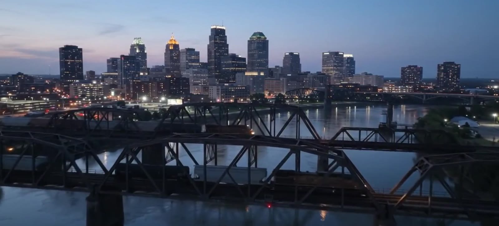 A city skyline and bridges across the water at dusk, from the original CoachOwens cinematic.